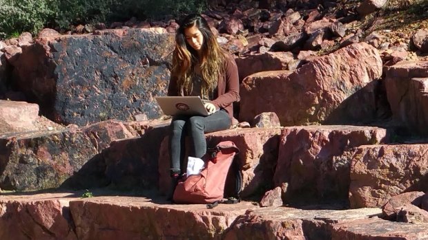 Australian National University student Victoria Jong catches up on studies connecting via CBRFree Wi-Fi in the Australian National Botanic Gardens.