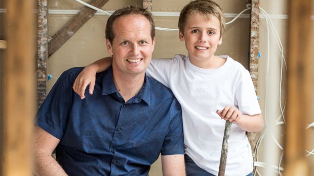 Scott Moffat with his son during the renovation.
