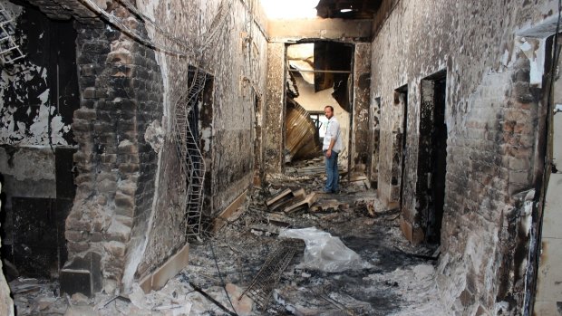 An MSF employee inside the charred remains of the Kunduz hospital last month.