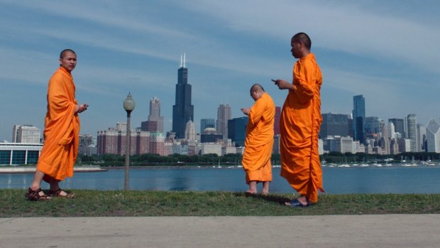 Buddhist monks with their smartphones in a scene from <i>Lo and Behold: Reveries of the Connected World</i>.