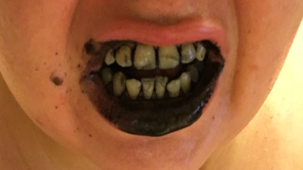 Catherine Bouris using charcoal toothpaste.