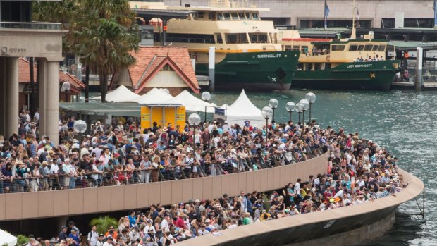 Crowds of people gather on the foreshore of Sydney Cove on Australia Day.