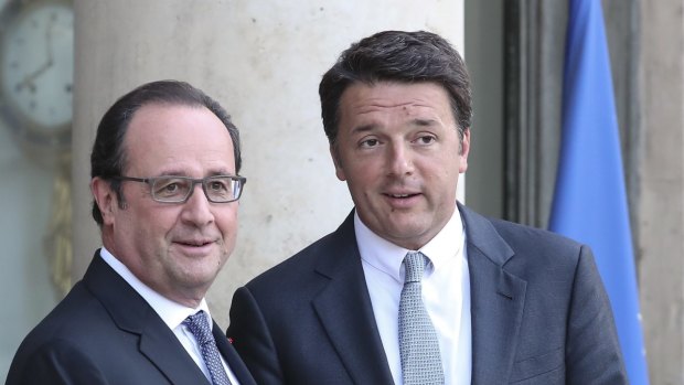 French President Francois Hollande, left, greets Italian Premier Matteo Renzi in Paris on Saturday. 