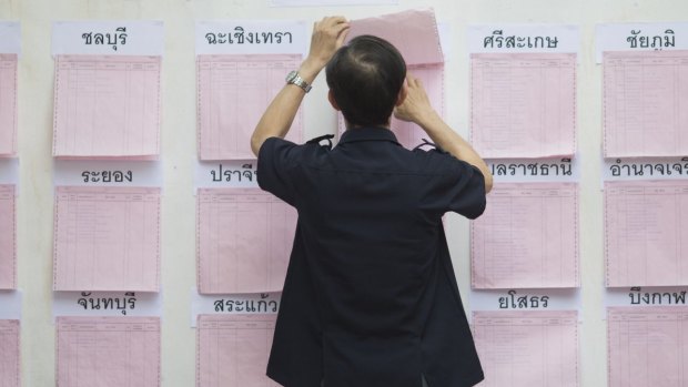 A voter checks a registration board at a polling station in Bangkok.