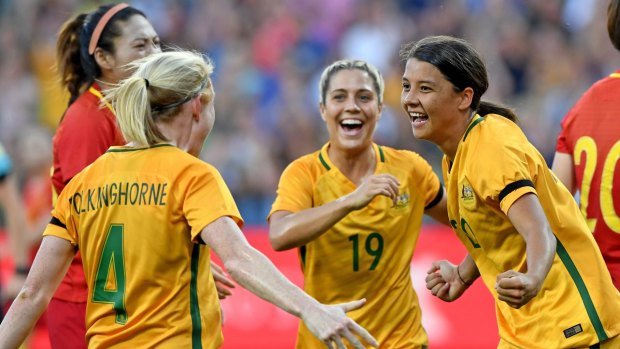 Sam Kerr (right) celebrates the first of her two goals against China at AAMI Park  on Wednesday night.
