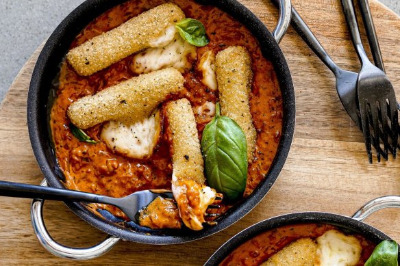 Baked mozzarella sticks with vodka sauce.