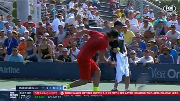 Thanasi Kokkinakis throws his racquet into the ground in frustration.