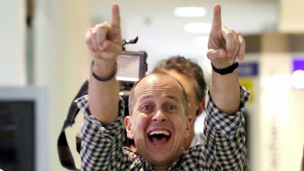 Australian journalist Peter Greste reacts upon his return home at Brisbane International Airport.