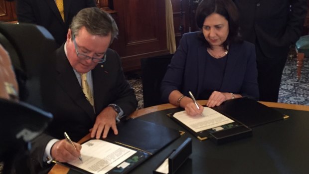 Star Entertainment chairman John O'Neill signs the final Queens Wharf Brisbane contract with Premier Annastacia Palaszczuk.