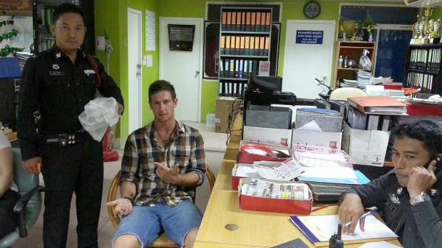 Jacob Saveisberg with police after allegedly stealing two raw prawns. 