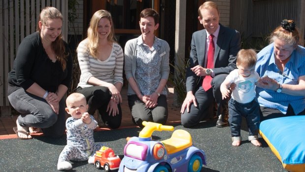 Deanne Kuhn, of Bonner, (far left) and her seven month son Ethan, with Health Minister Simon Corbell and midwives Vanessa Bakker (centre) and Marguarita van Oosten, holding Reya, eight months, at the QEII Family Centre in Curtin on Friday.