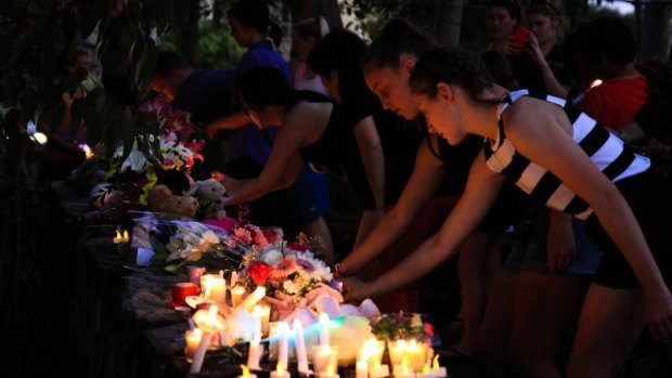 Community members attend a candlelight vigial for Queenie Xu.