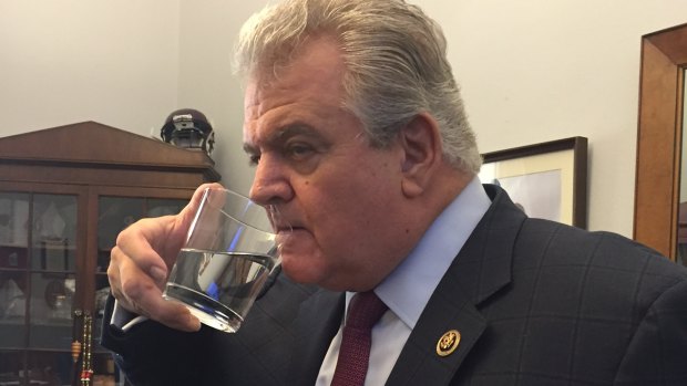 Congressman Bob Brady  drinks from a glass of water that Pope Francis used during his speech to Congress.