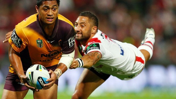 Anthony Milford of the Broncos is tackled by Benji Marshall.