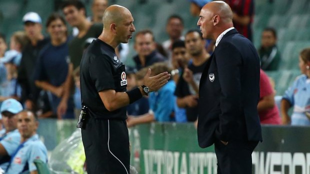 Artistic differences: Referee Strebre Dilovski speaks to Melbourne Victory coach Kevin Muscat on the sidelines on Saturday night.