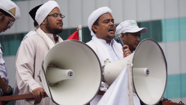 Muhammad Rizieq Shihab, also known as Habib Rizieq, addresses protesters outside Indonesian police headquarters.  