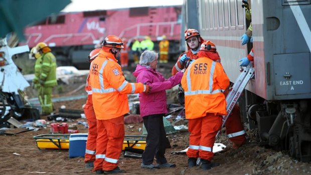 Emergency services help passengers off the V-Line train.