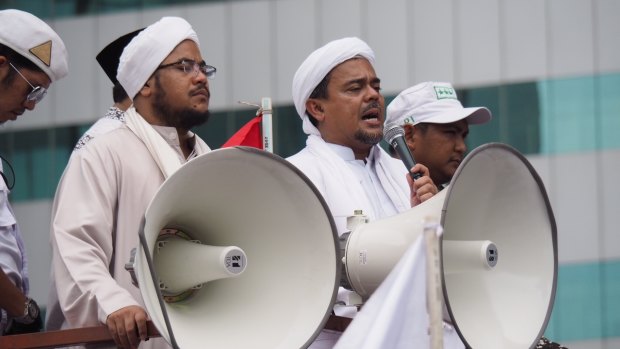 Rizieq Shihab (with microphone) speaks at a protest in Jakarta in January. 