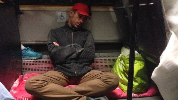 A migrant sleeps on the bus provided by Hungary to take hundreds of refugees away.