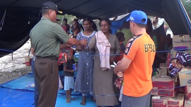 Sri Lankans receive supplies from Indonesia while at the tent camp.