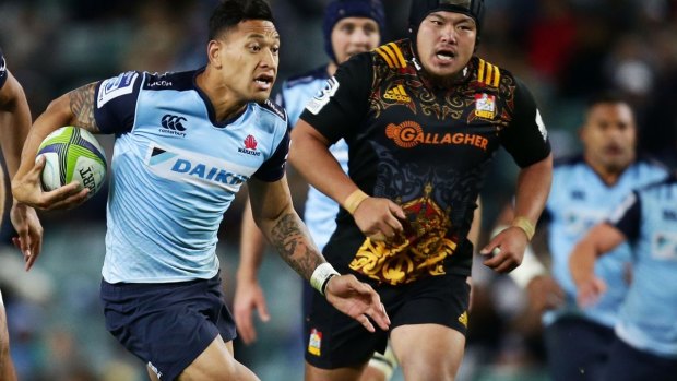 Man on fire: Israel Folau makes a break on Friday night.