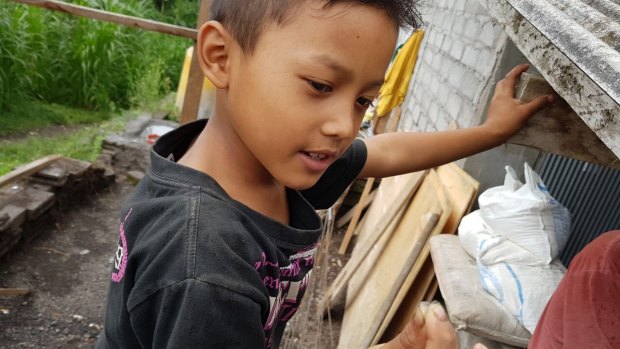 Gede Epo from Nawa Kerti village five kilometres from Mount Agung summit shows ash he picked from the roof.