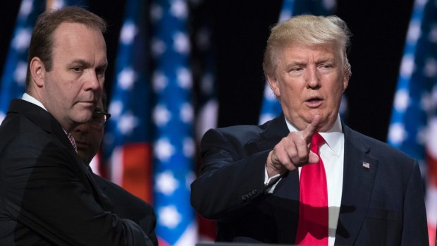 Donald Trump pictured with campaign aide Rick Gates, who surrendered to the FBI on Monday. 