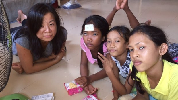 American volunteer Ame (left) with three of 65 children at the Poor Street Children and Orphans Training Centre in a suburb of Phnom Penh. Most of the children there are not orphans.