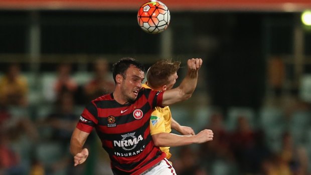 Airborne: Mark Bridge of the Wanderers and Jacob Poscoliero of the Mariners compete for the ball.