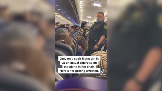 US deputies approach the woman to remove her from the flight.
