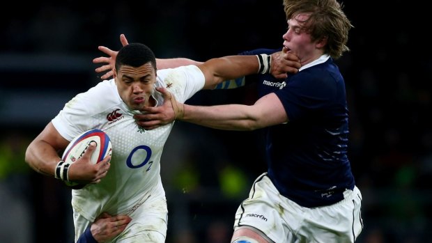 Lost opportunities: Luther Burrell of England is tackled by Rob Harley (left) and Jonny Gray (right) of Scotland.