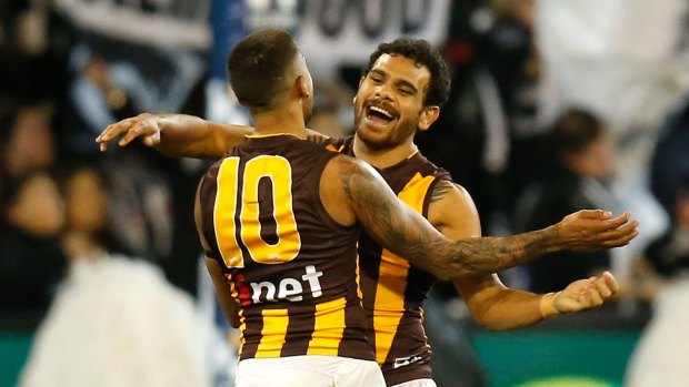 Bradley Hill and Cyril Rioli of the Hawks rejoice after a goal.