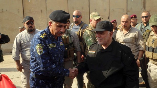 Iraqi Prime Minister Haider al-Abadi, right, shakes hands with Lieutenant-General Raid Shaker Jawlat upon his arrival in Mosul on Sunday.