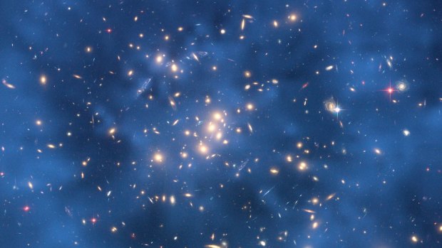 This Hubble Space Telescope composite image shows a ghostly "ring" of dark matter in the galaxy cluster.