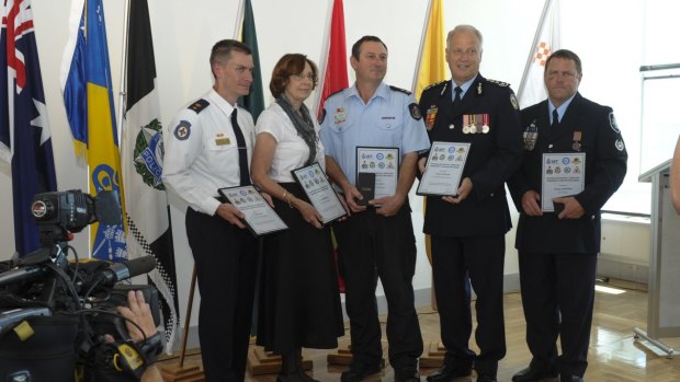 Five recipients of the ACT Community Protection Medal, from left, Toby Keene, ACT Ambulance Service, Pauline Wassall, ACT Rural Fire Service, Andrew Cahill, ACT Fire and Rescue, Tony Graham, ACT State Emergency Service and Station Sergeant Rodney Anderson, ACT Policing. 