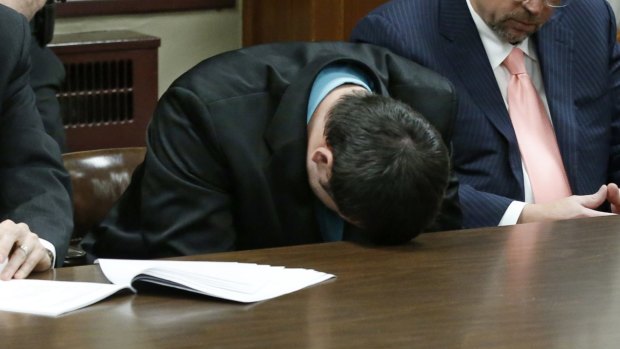 Guilty: Daniel Holtzclaw puts his head on the table and cries as the verdicts are read.