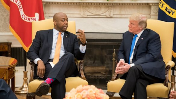 US President Donald Trump speaks to Senator Tim Scott in a White House meeting on September 13, 2017.