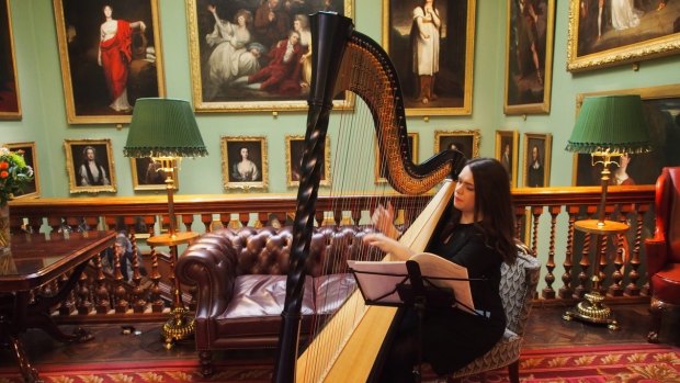 A harpist playing in the reception area of the Garrick Club.