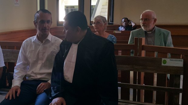 David Taylor waiting for his trial to start at Denpasar District Court on Wednesday, with his lawyer Haposan Sihombing (right) and behind him his parents John and Janet.