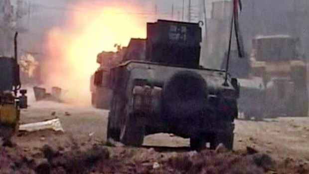 A tank fires during clashes in Fallujah, Iraq