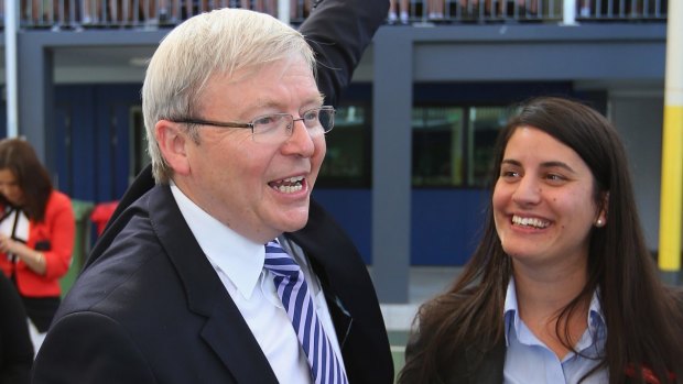 Then prime minister Kevin Rudd waves to children during a visit to Brisbane Adventist College with Laura Fraser Hardy in 2013.
