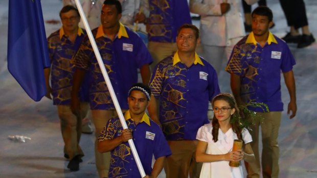 Flag bearer Elson Brechtefeld of Nauru leads his team during the Opening Ceremony.