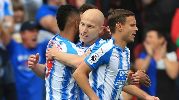 Huddersfield's Australian midfielder Aaron Mooy celebrates with teammates after scoring against Newcastle on Sunday.