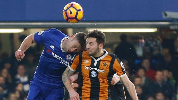 Chelsea's Gary Cahill (left) and Hull City's Ryan Mason challenge for the ball.