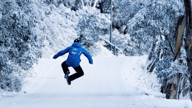 A Mt Buller ski instructor jumps for joy at the sight of fresh snow. 