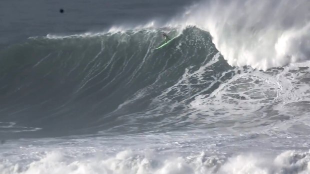 Garrett McNamara takes off on the monster wave.