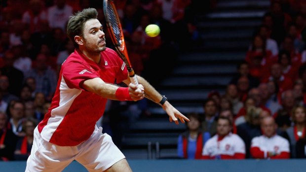 One up: Stan Wawrinka plays a volley during his four-set victory over Jo-Wilfried Tsonga in the opening Davis Cup match.