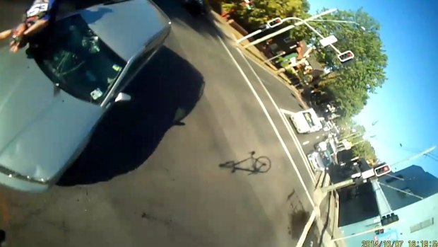 Terrifying moment: Cyclist Paul Ludlow hits the car windscreen, the shadow of his bike visible on the right.
