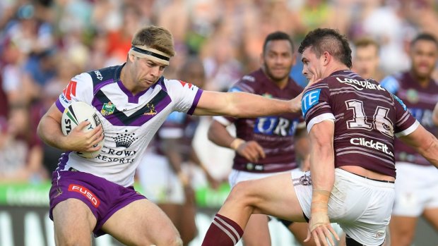 Fend off: Christian Welch keeps Manly's Darcy Lussick at bay in round seven action.