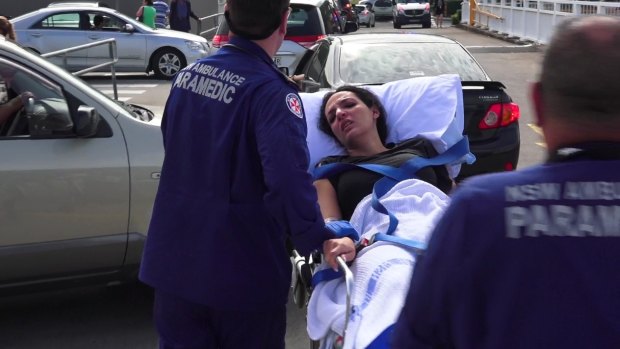 Innocent bystander: a woman receives treatment after the Bankstown shooting.